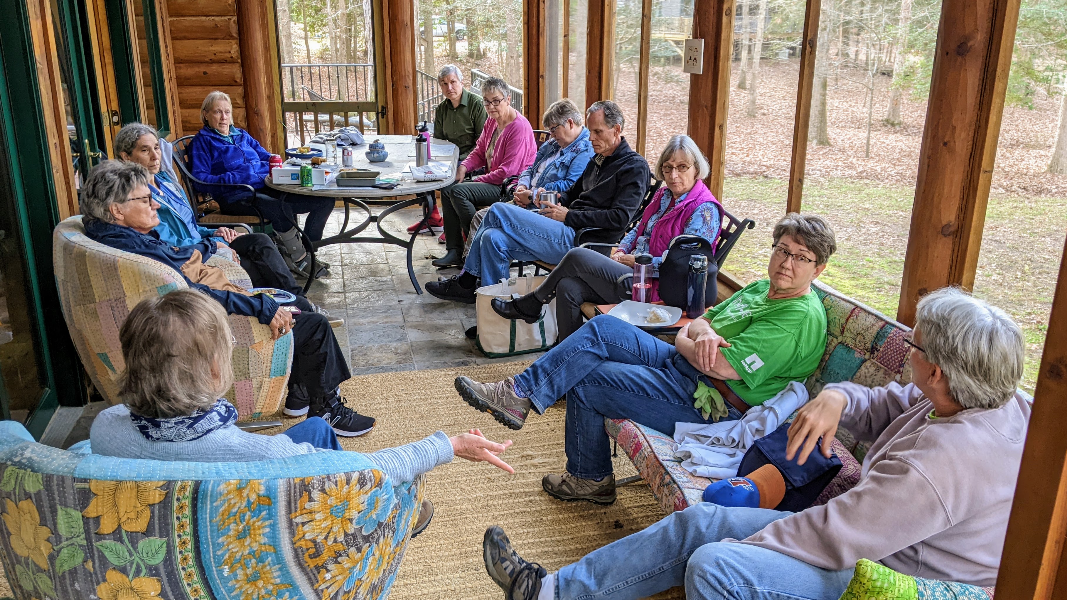 Group of people meeting together on a screened porch.